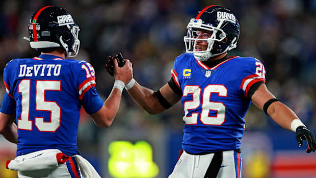 Tommy DeVito celebrates a touchdown with Saquon Barkley.